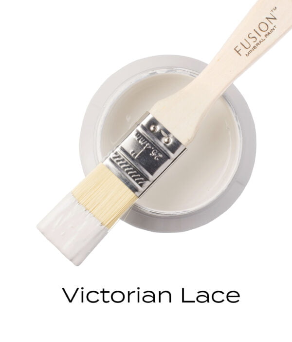 An angled brush that has been dipped in, and then placed on top of an open pint of Victorian Lace Fusion mineral paint to indicate the colour.