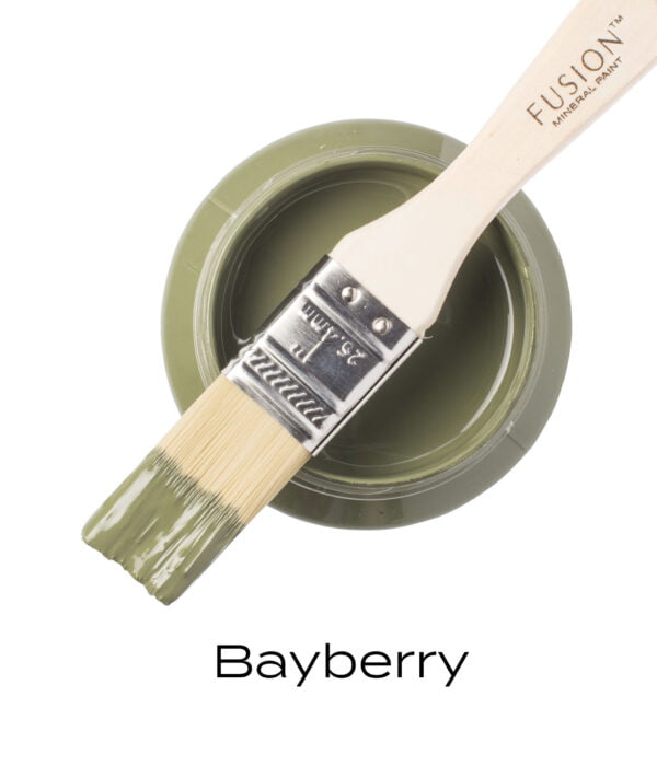 An angled brush that has been dipped in, and then placed on top of an open pint of Bayberry Fusion mineral paint to indicate the colour.