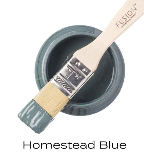 Angled Brush on top of an open pot of Homestead Blue Fusion mineral paint.