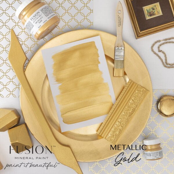 A wooden handle, plate, and other items painted with the Metallics Gold Fusion mineral paint.